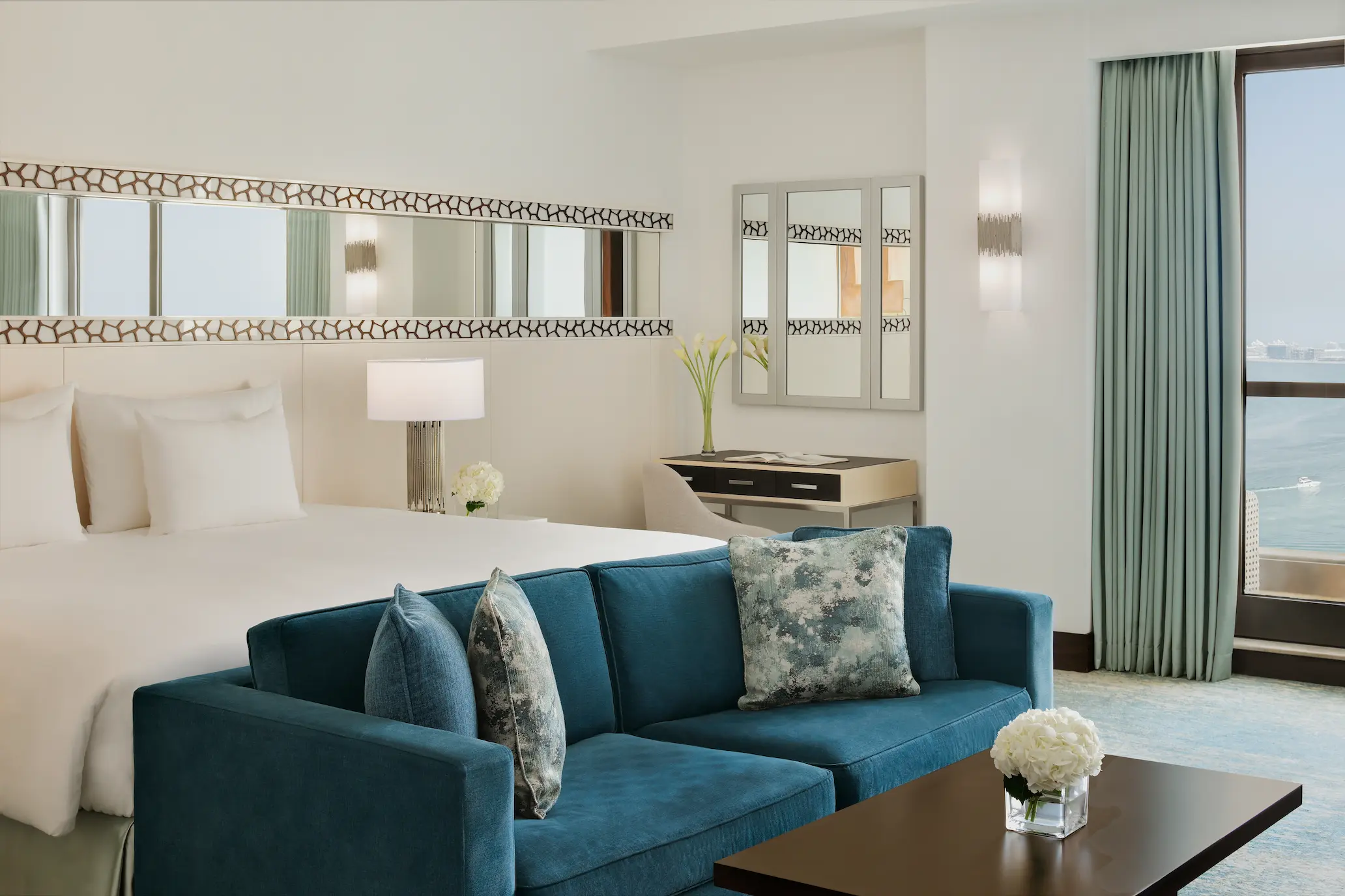 sea view junior suite bed at ja ocean view hotel overlooking the arabian gulf