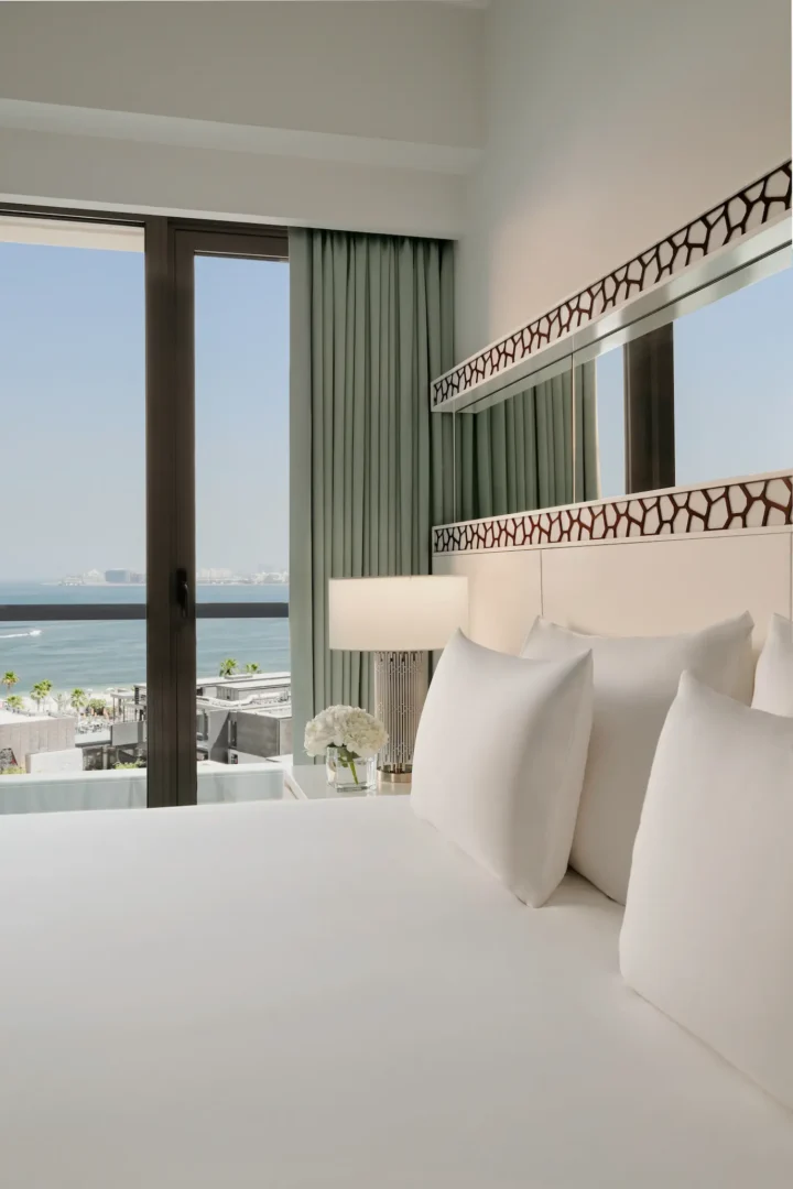close-up of king bed in sea view room at JA Ocean View Hotel with crisp linens and soft pillows