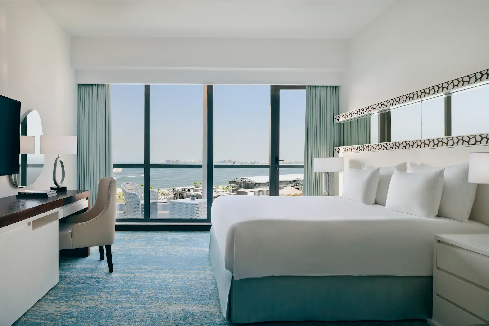 desk workspace in sea view room at JA Ocean View Hotel with natural light and coastal views