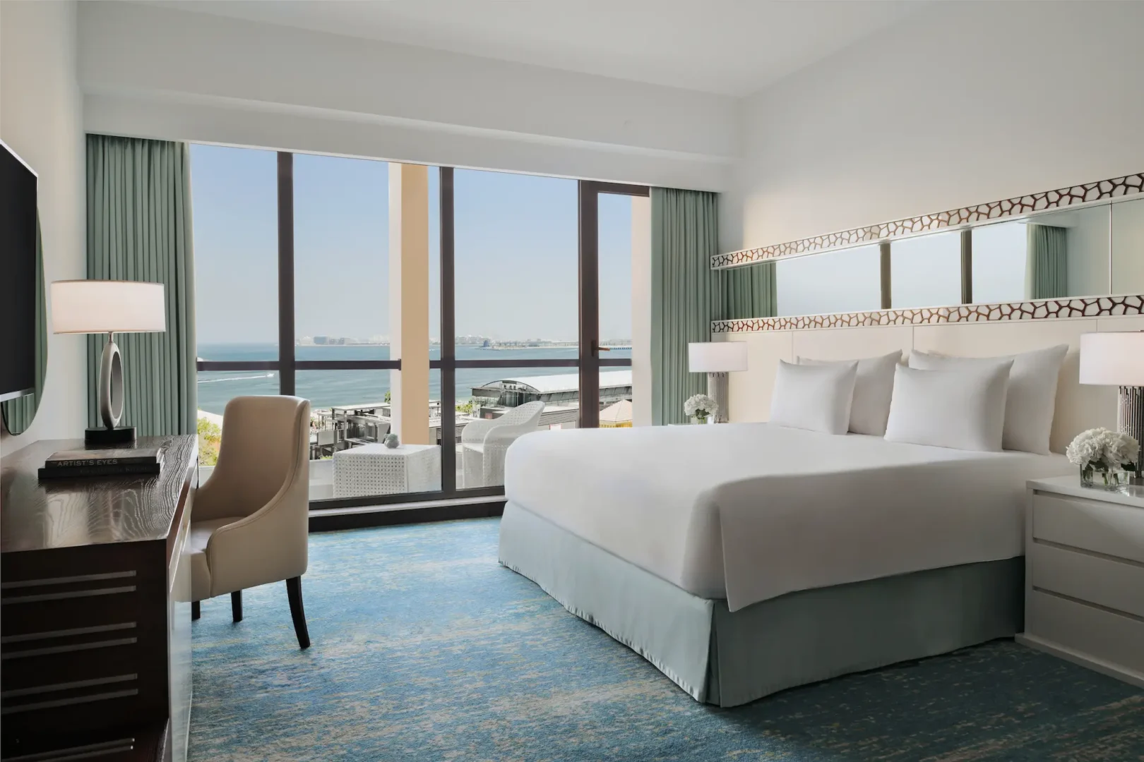 king bed in sea view room at JA Ocean View Hotel overlooking the arabian gulf
