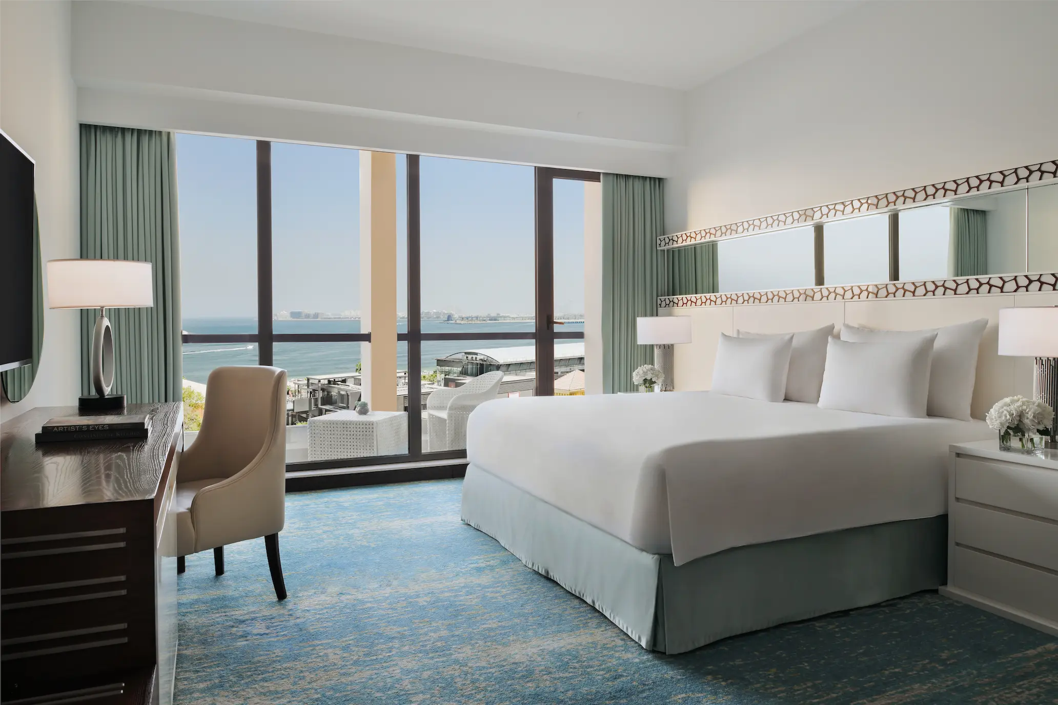 king bed in sea view room at JA Ocean View Hotel overlooking the arabian gulf
