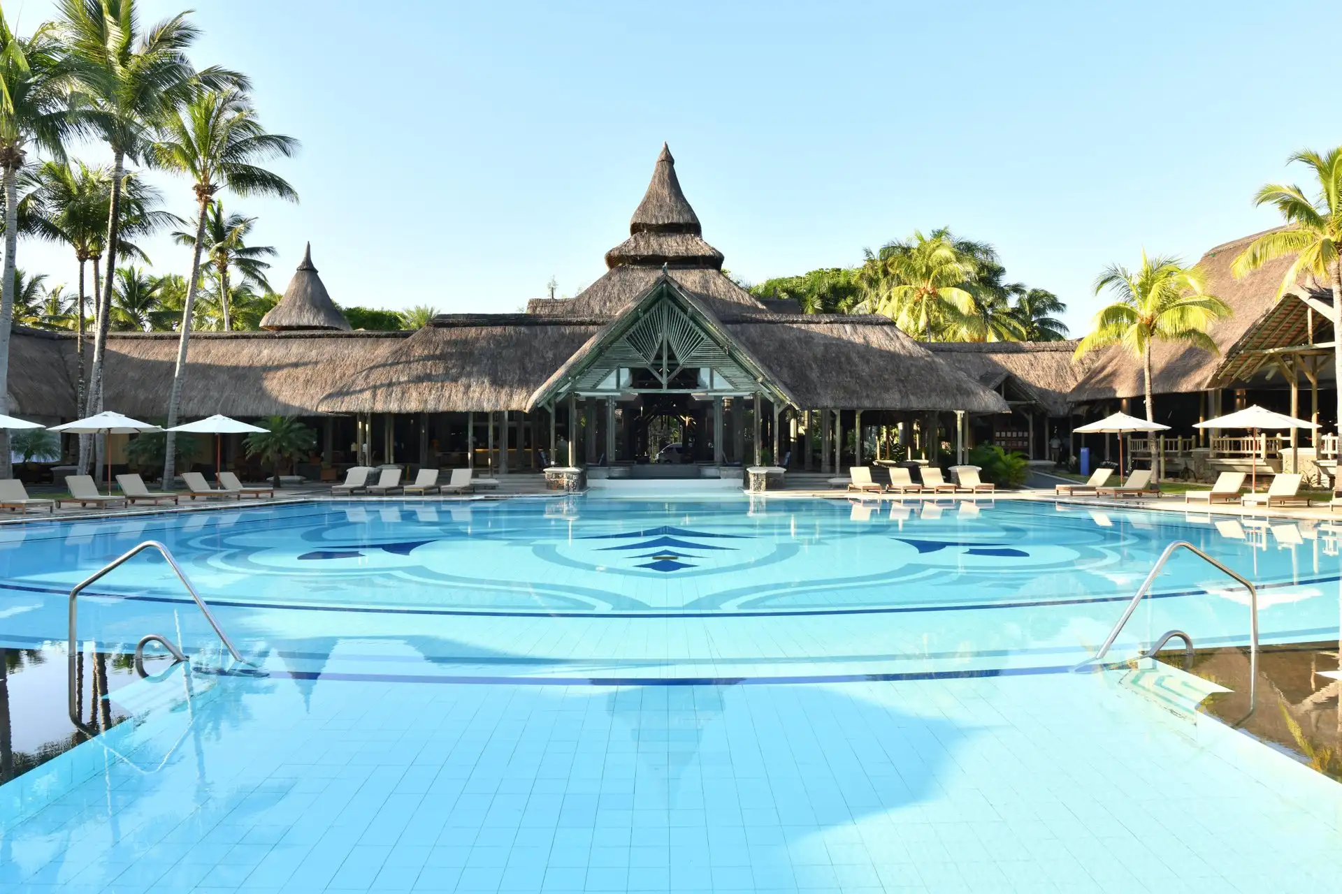 pool and resort building at shandrani beachcomber resort and spa with large swimming pool framed by tropical gardens and guest accommodations