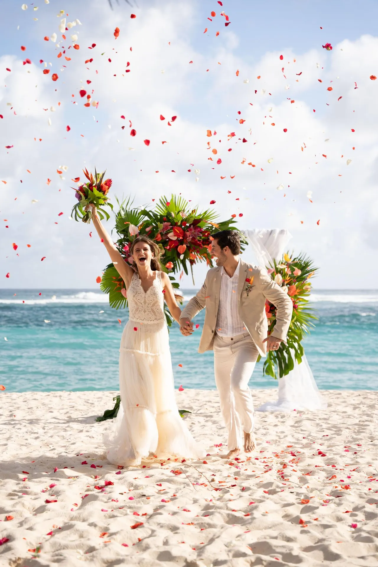 shandrani mauritius wedding confetti celebration with bride and groom outside tropical resort