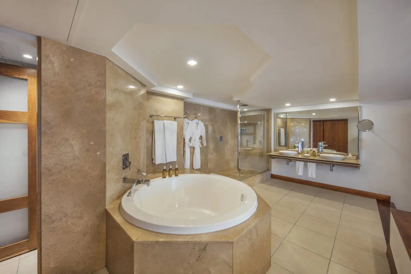 elegant senior suite bathroom at shandrani resort with bathtub, shower, and modern fixtures