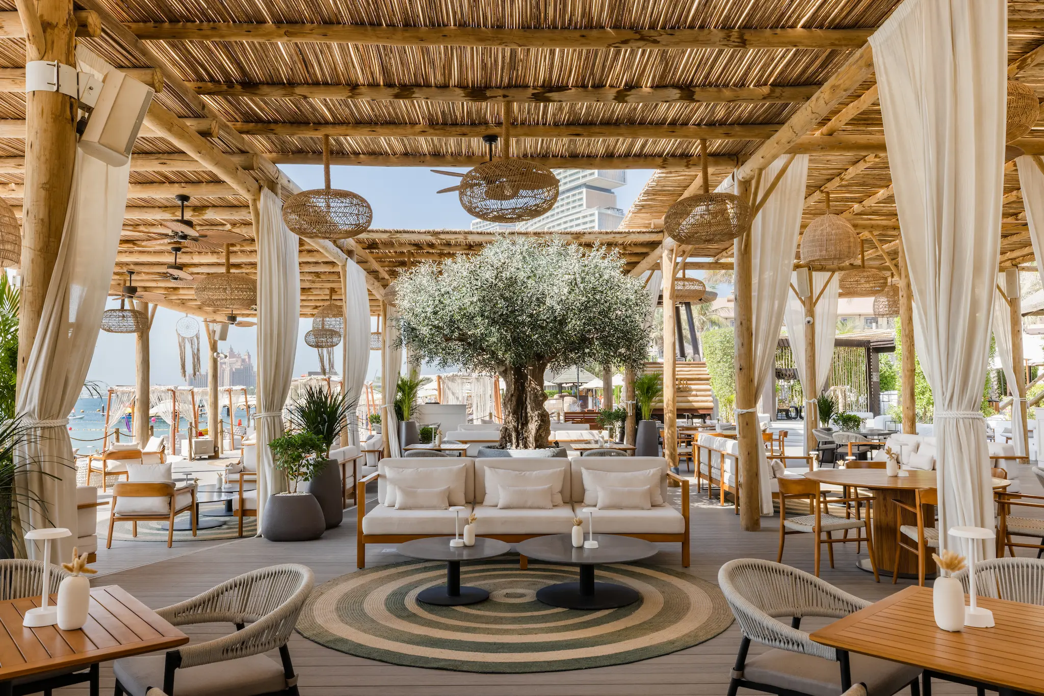 laguna beach taverna & lounge at sofitel dubai the palm with outdoor seating, beachside views, and mediterranean dining ambiance