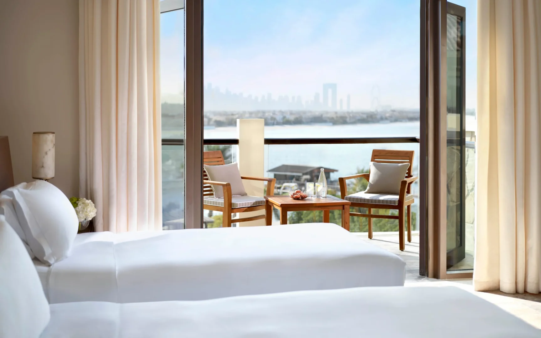 luxury room at sofitel dubai the palm with palm view, modern decor, king bed, and private balcony overlooking lush landscaping