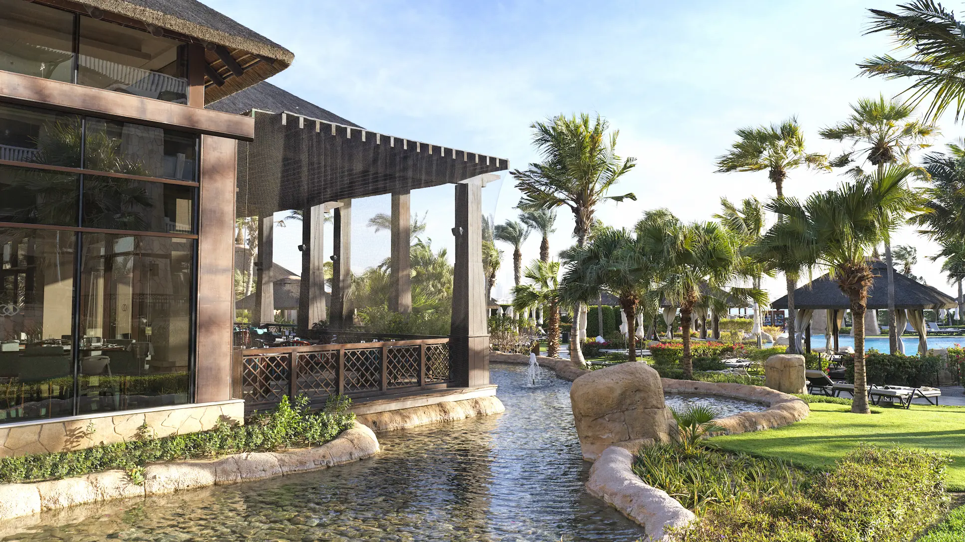 exterior view of moana at sofitel dubai the palm during daytime with beachfront setting, tropical landscaping, and resort architecture