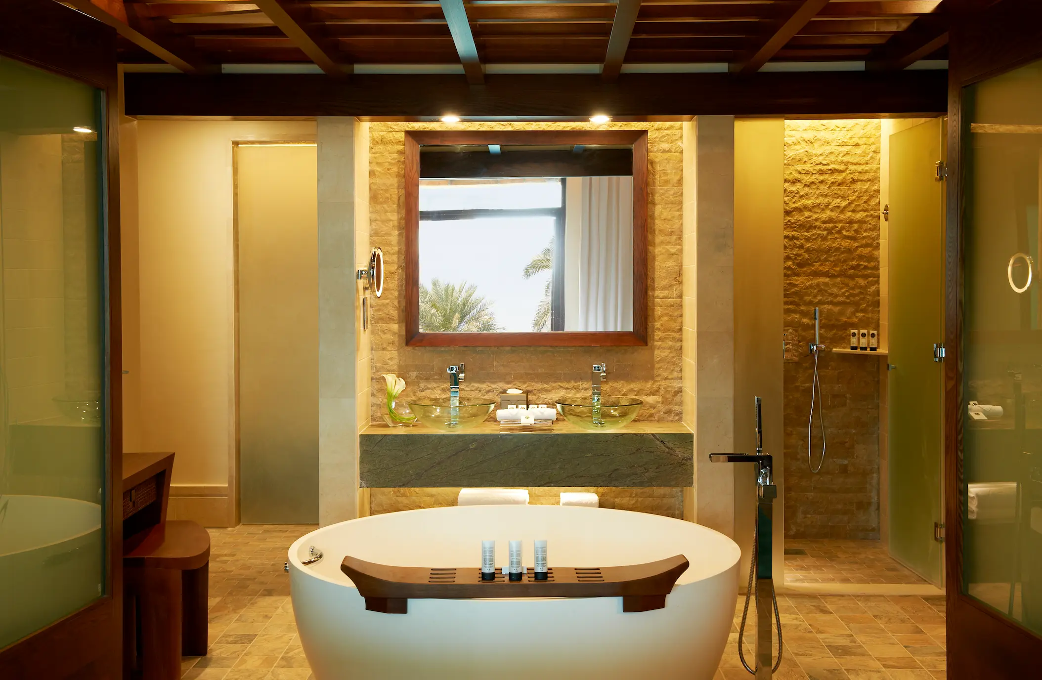 bathroom in prestige suite at sofitel dubai the palm with modern design, double sinks, walk-in shower, bathtub, and luxury finishes