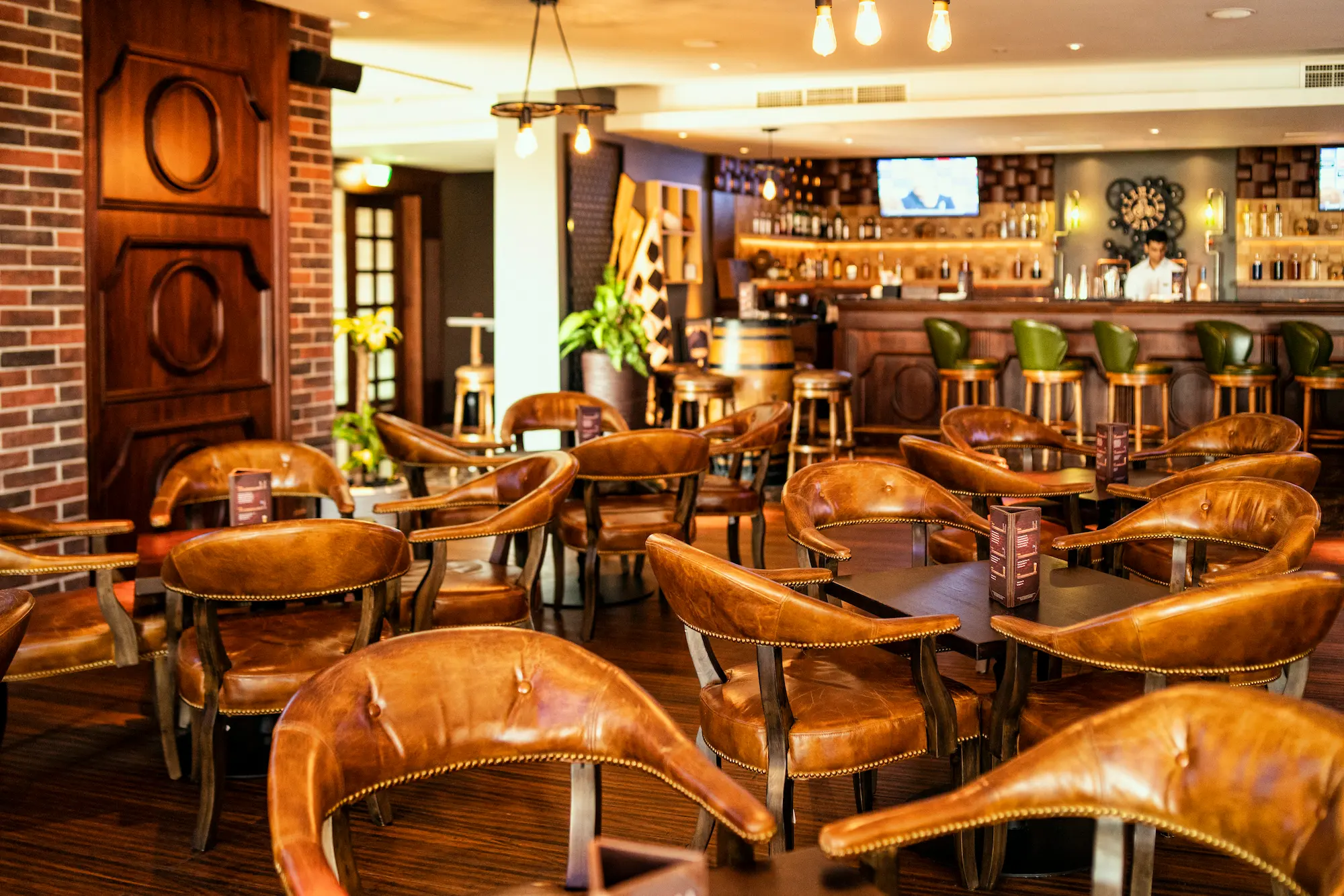 replay sports bar at sofitel dubai the palm with large screens, casual seating, and lively sports lounge atmosphere