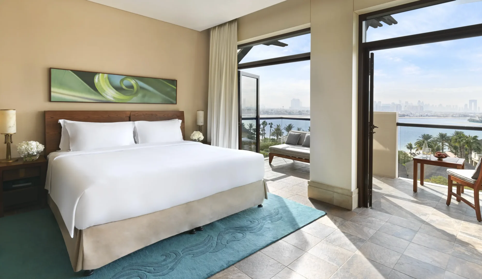 bedroom in two-bedroom sea view apartment at sofitel dubai the palm with king bed, modern decor, and private balcony overlooking the Arabian Gulf