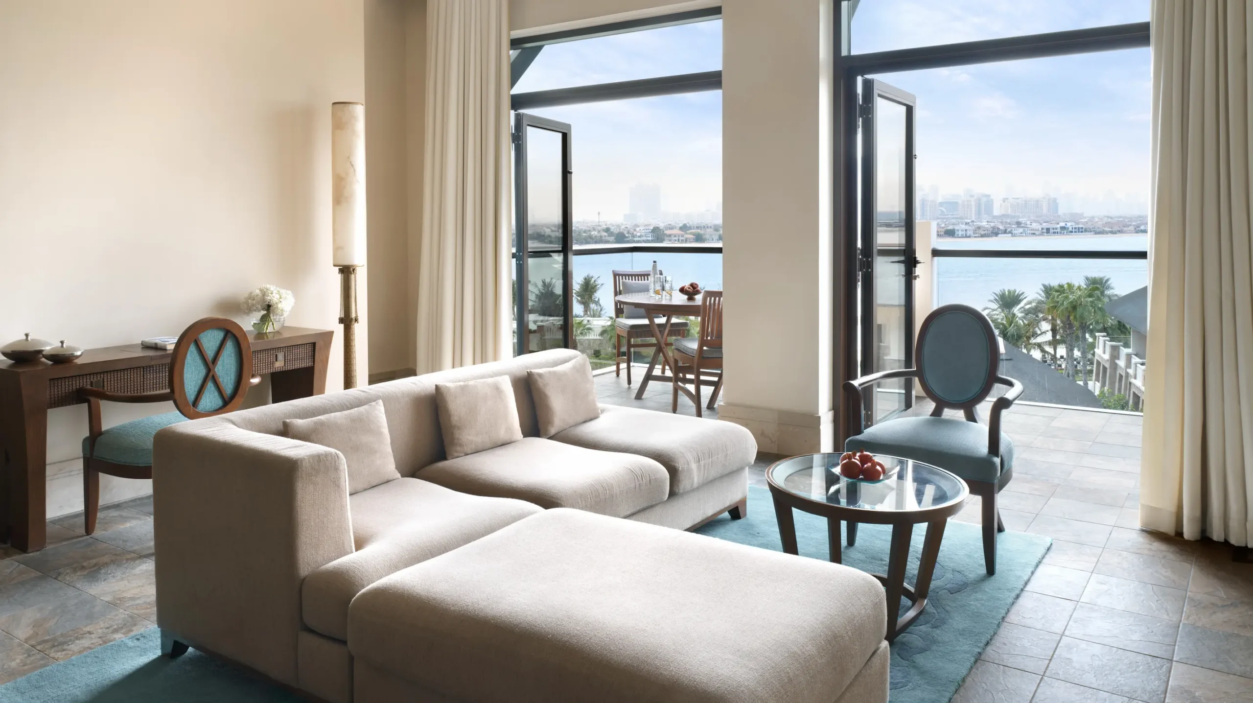 living area in two-bedroom sea view apartment at sofitel dubai the palm with modern decor, comfortable seating, and balcony overlooking the Arabian Gulf