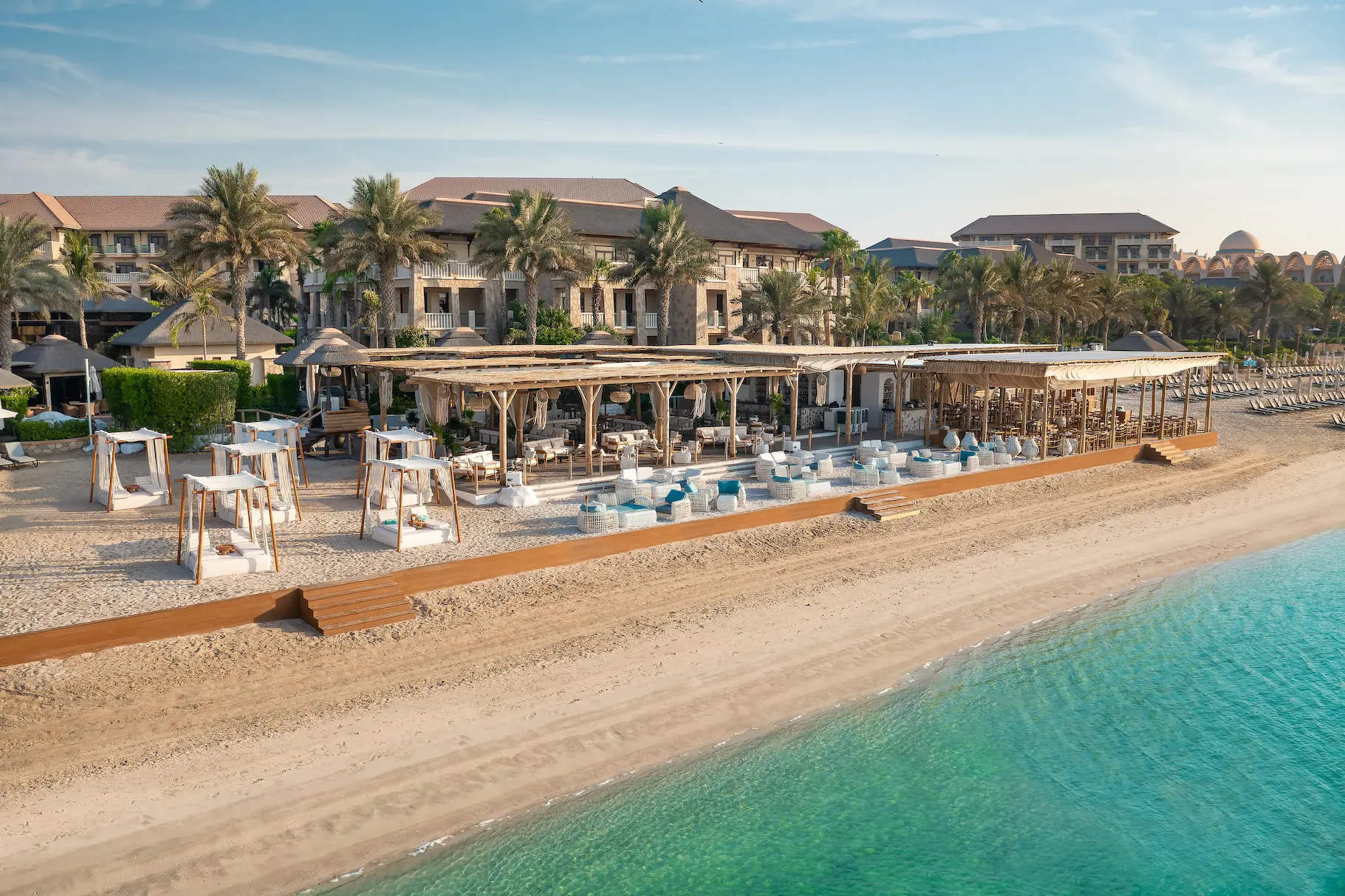 beach view at sofitel dubai the palm showing private shoreline, sun loungers, and views across the arabian gulf