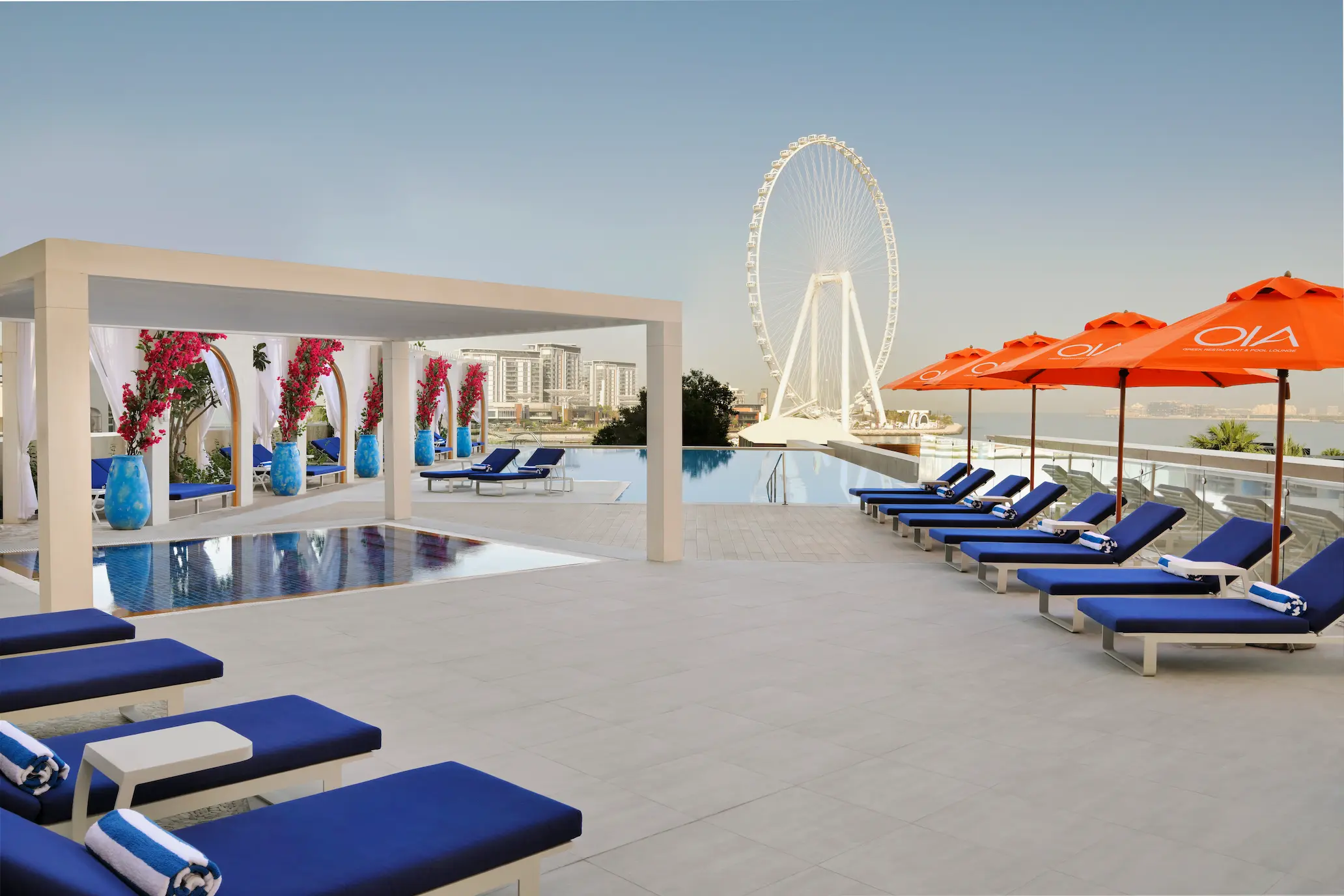 swimming pool with sunbeds at ja ocean view hotel overlooking the arabian gulf
