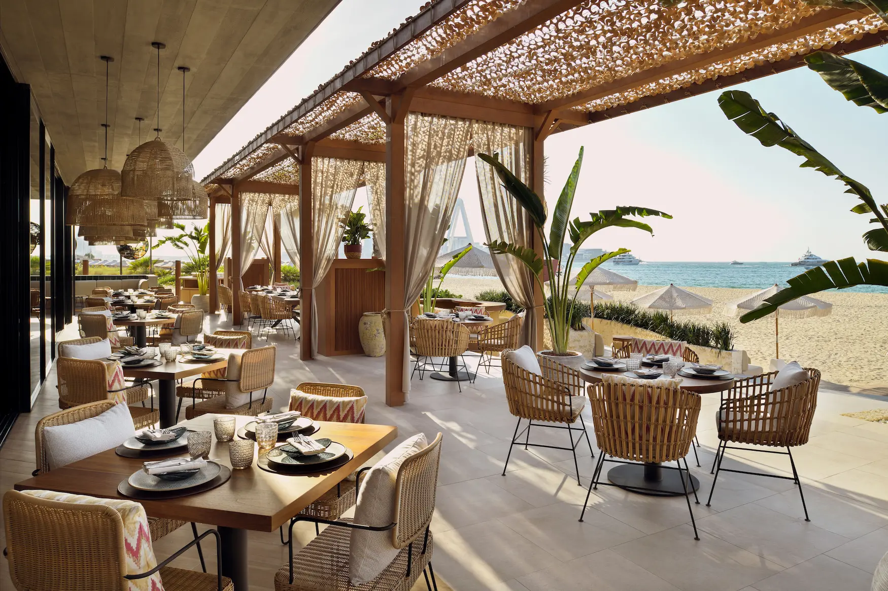 tamoka terrace daytime at the ritz-carlton dubai jbr featuring beachfront dining, relaxed outdoor seating, and views of the arabian gulf in dubai marina