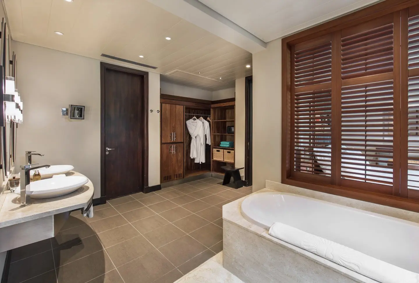 trou aux biches 2 bedroom family suite bathroom with modern fixtures, bathtub, and bright, airy design