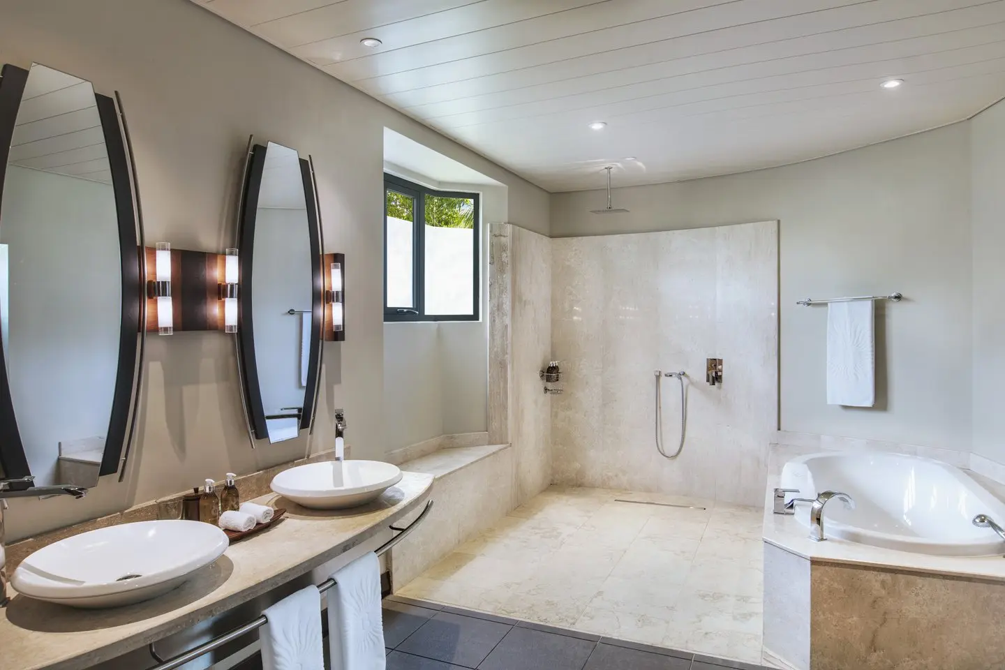trou-aux-biches junior suite bathroom shower with glass enclosure, modern fixtures, and bright natural lighting