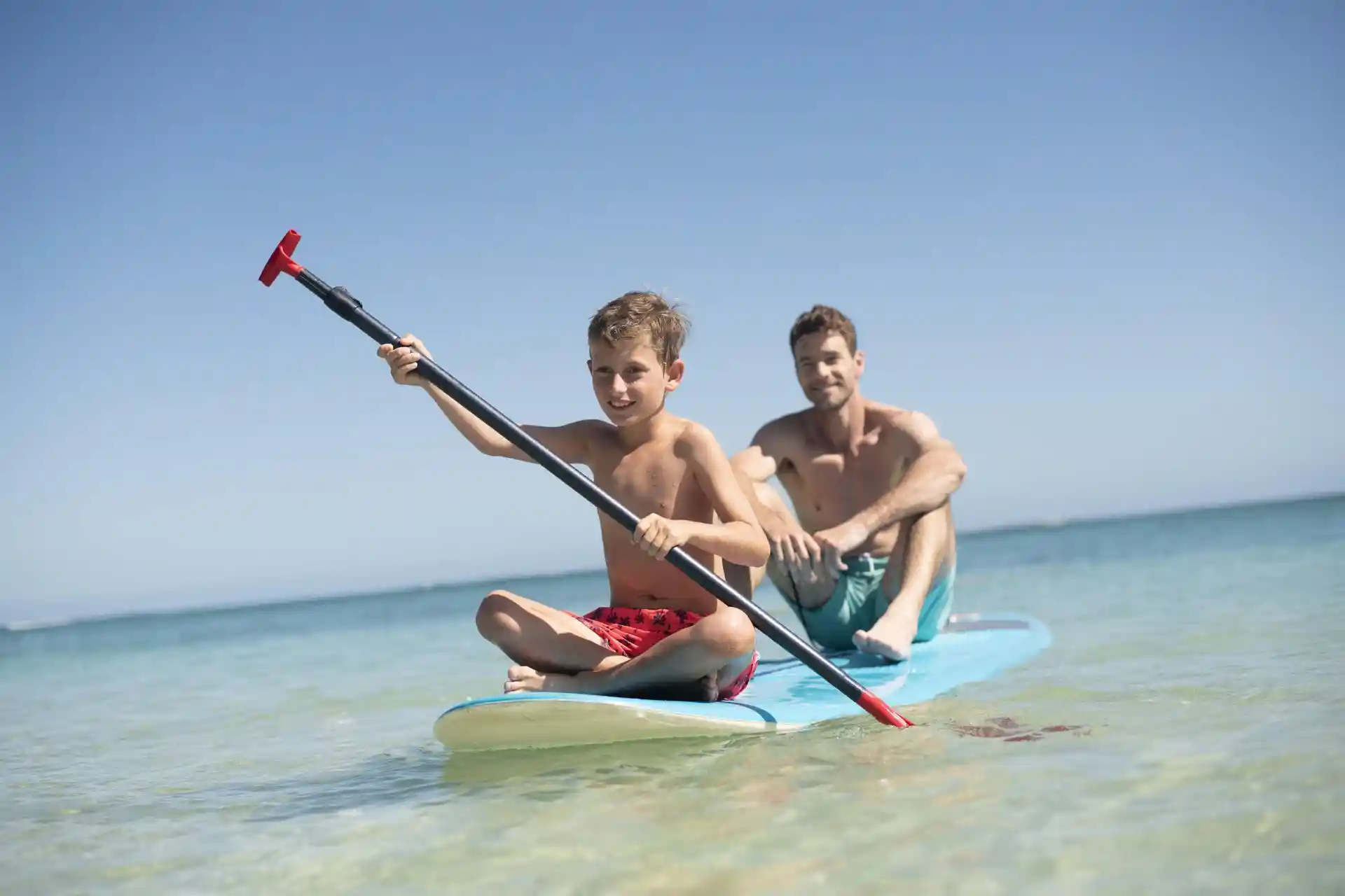 trou aux biches mauritius kayak activity on turquoise lagoon with tropical beachfront setting