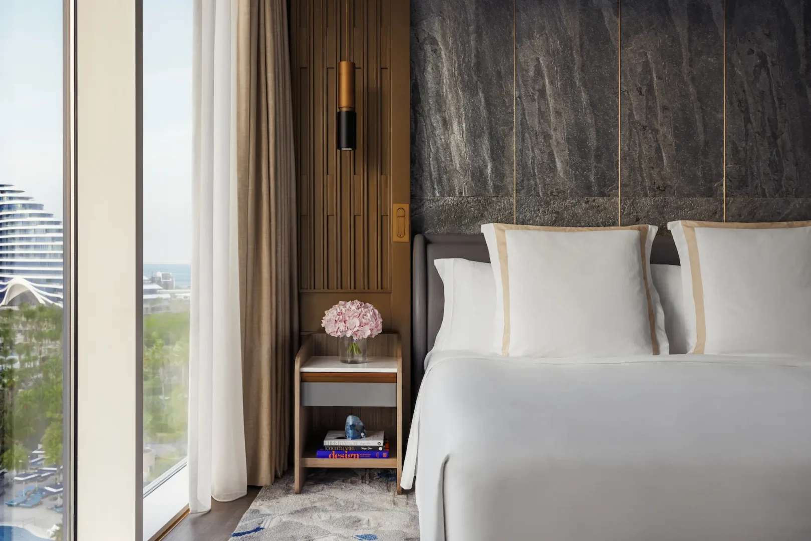 bedroom in two bedroom suite at Jumeirah Beach Hotel with king bed, contemporary furnishings and sea-inspired décor