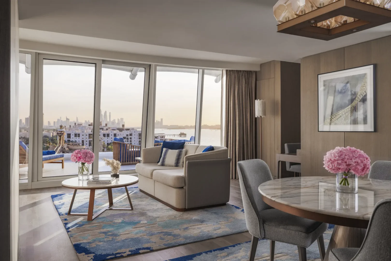 living and dining area in two bedroom suite at Jumeirah Beach Hotel with modern furnishings and sea-inspired décor