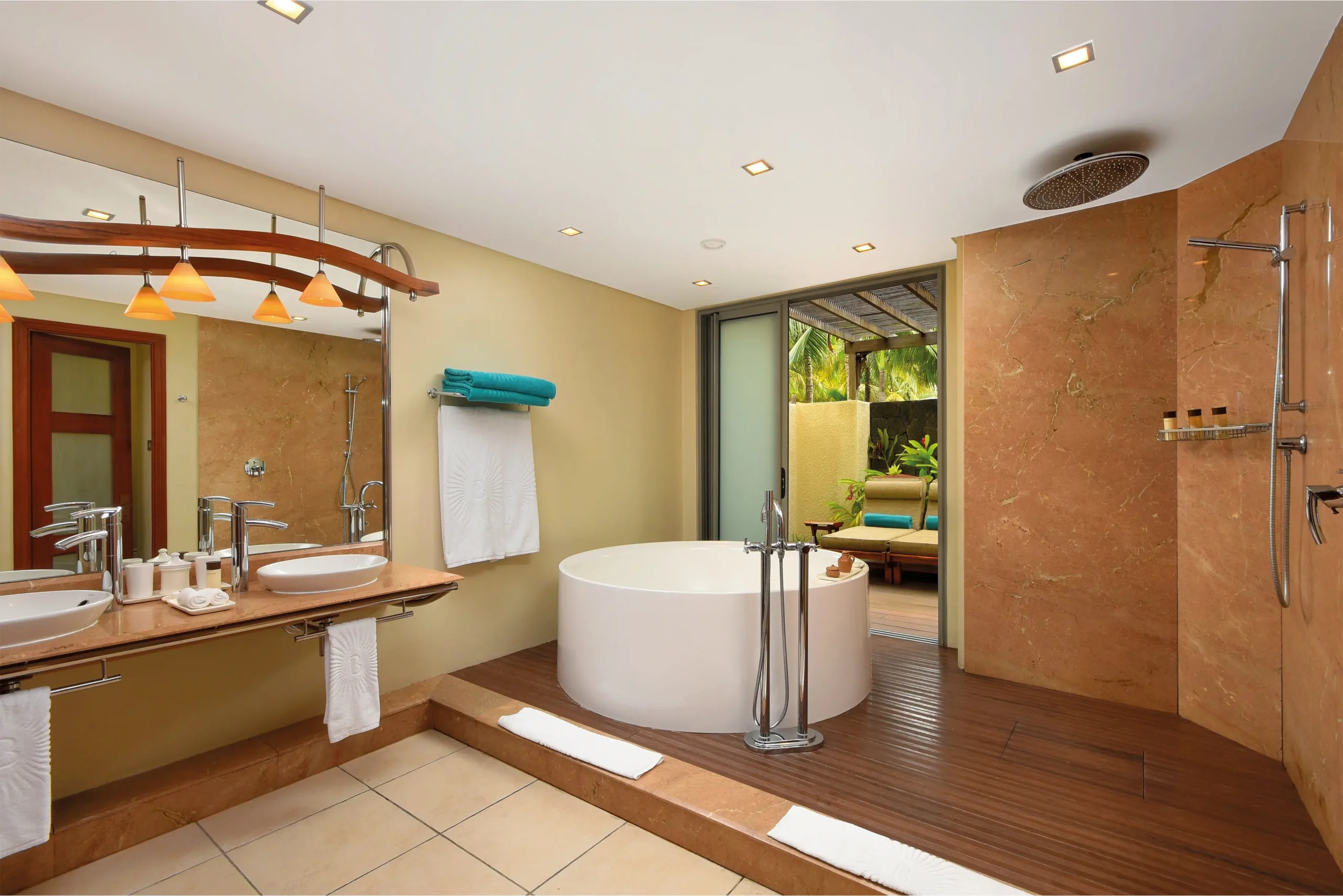 luxurious bathroom in two-bedroom family suite at shandrani resort with stand-alone bathtub, shower, and modern fixtures