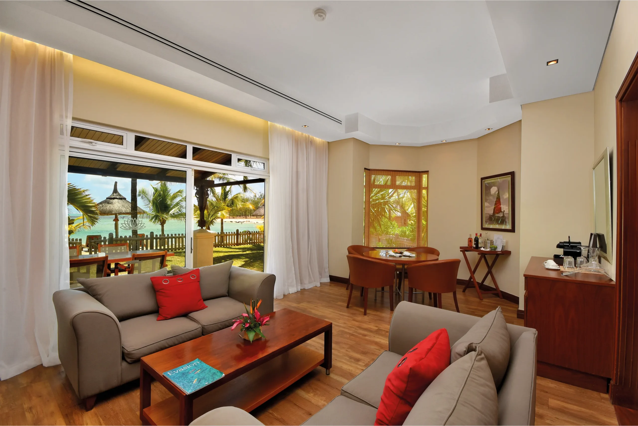 spacious two-bedroom family suite lounge at shandrani resort with comfortable seating and large windows overlooking the beachfront