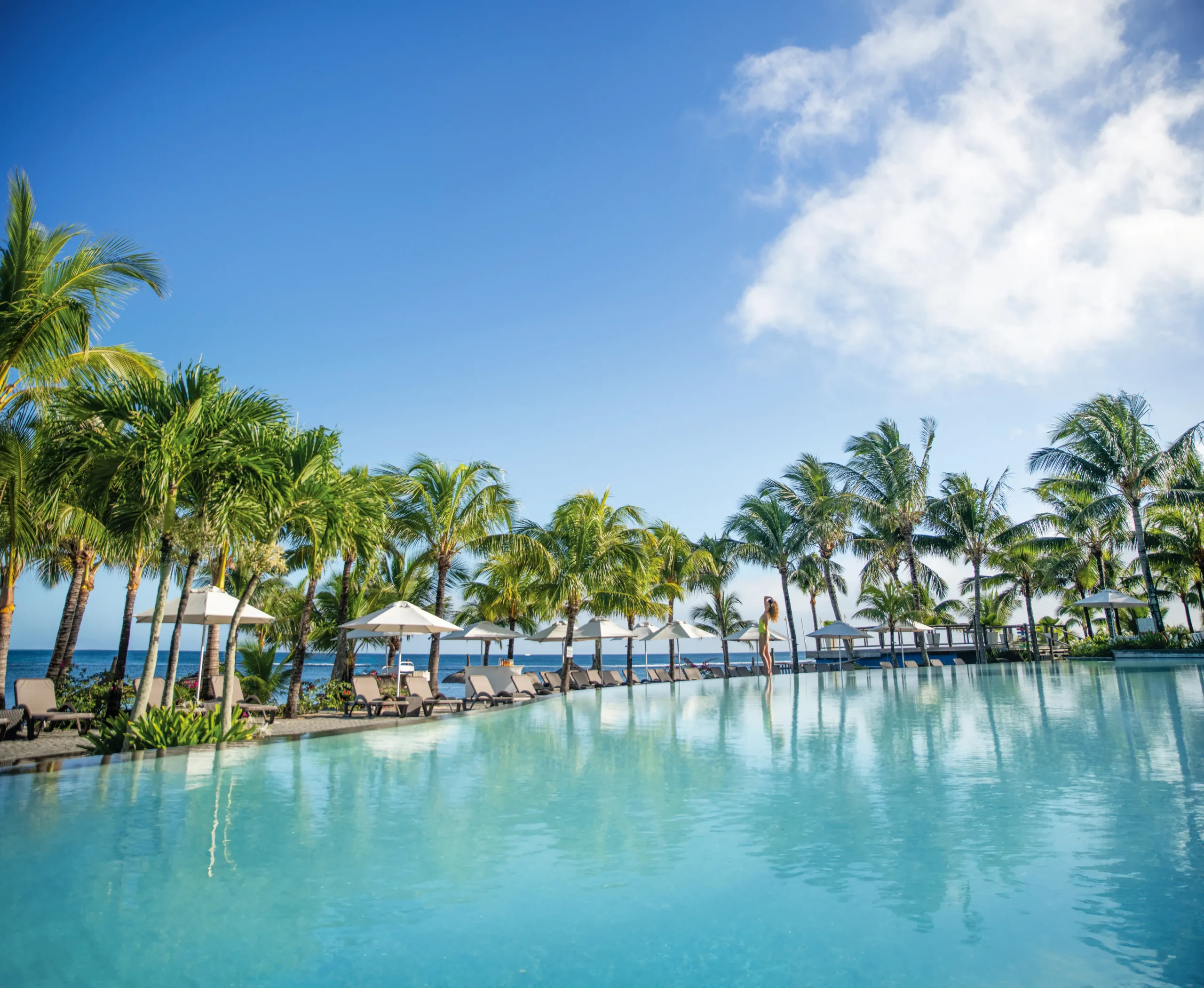 victoria beachcomber mauritius lifestyle main pool in a sunlit lagoon setting
