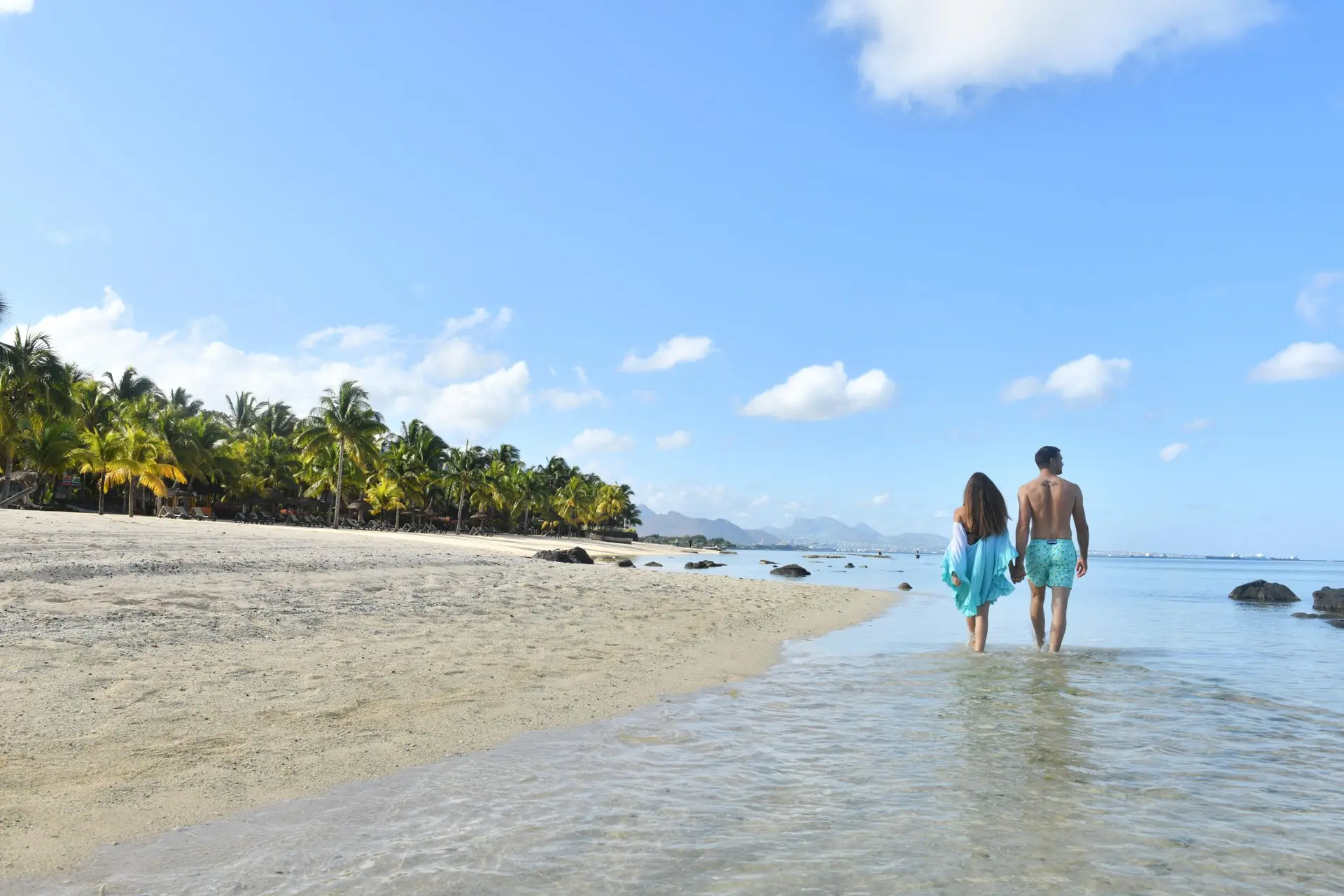victoria mauritius beach couple walking along sandy shore romantic scene