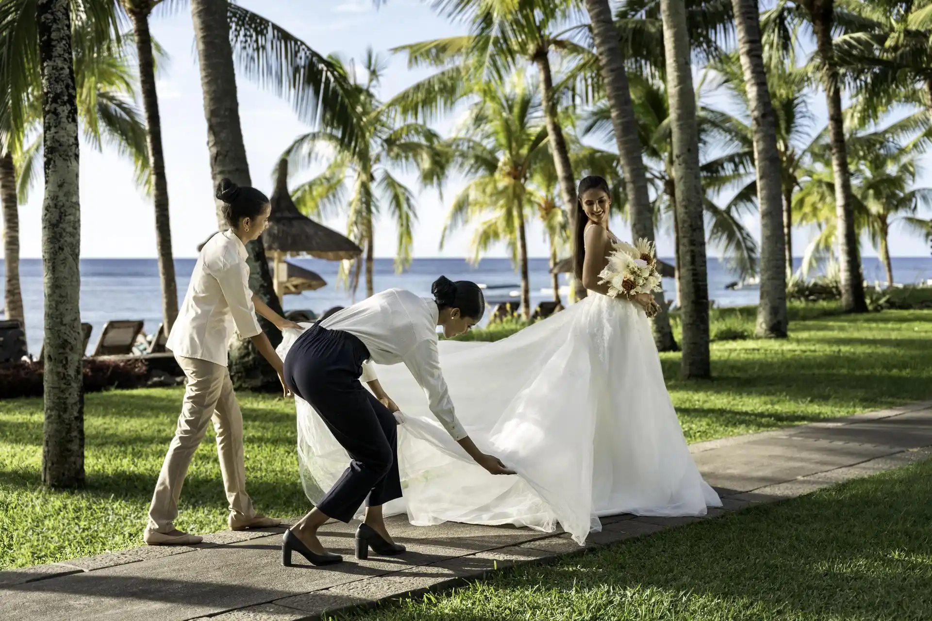 victoria mauritius wedding bride in white gown standing on tropical beachfront