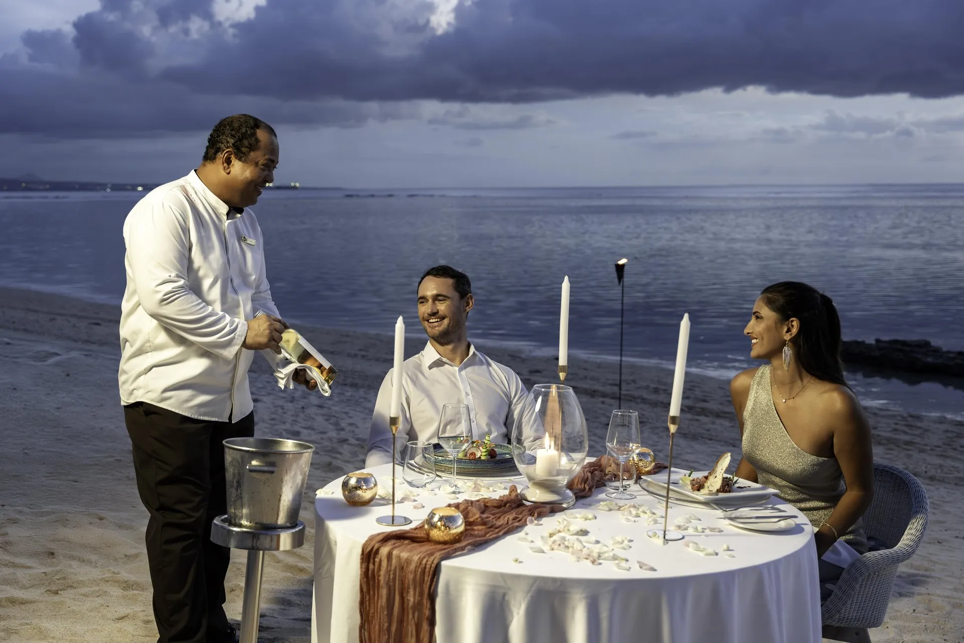 victoria mauritius wedding meal with guests dining outdoors under tropical decorations