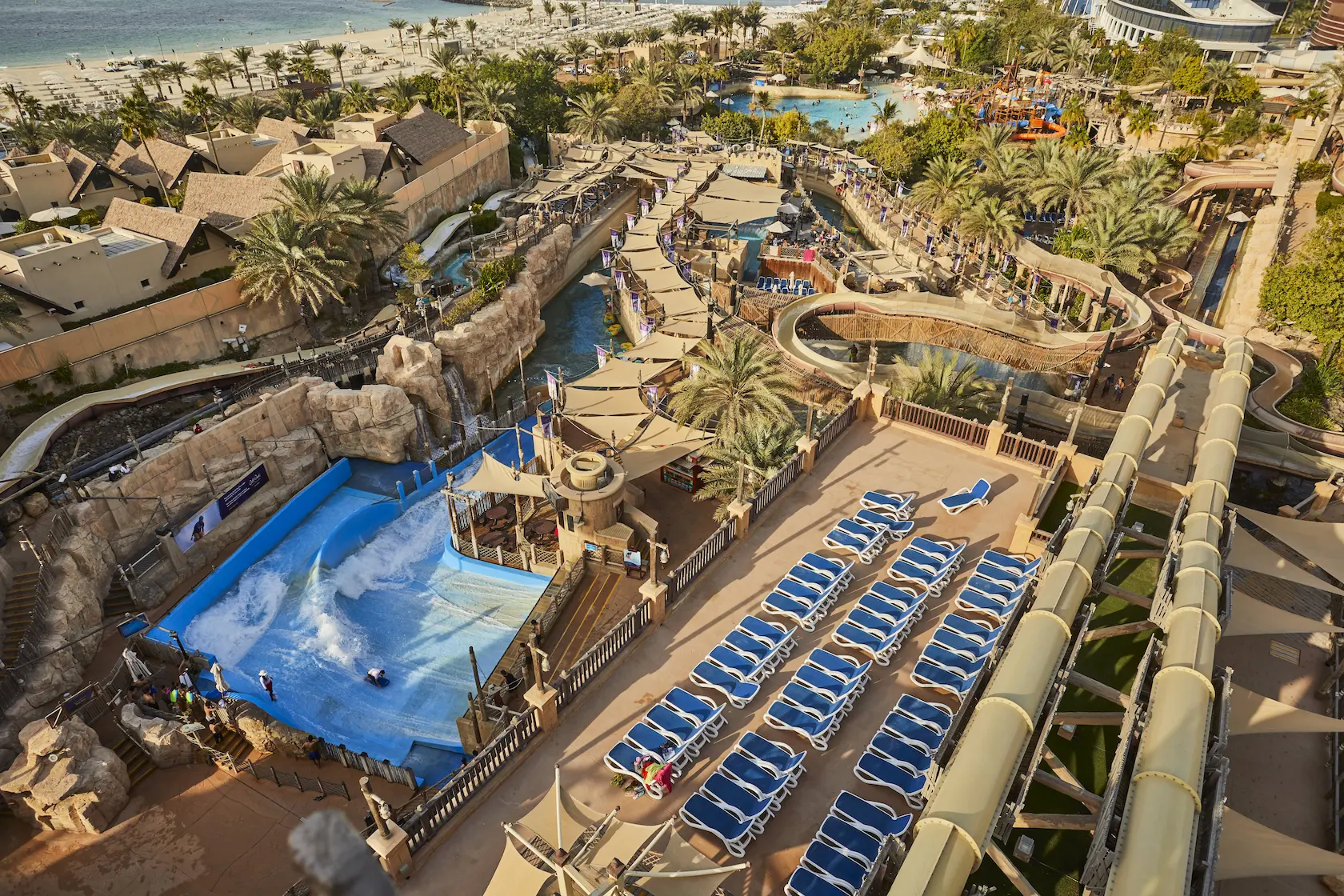 aerial view of wild wadi waterpark dubai showing water slides, pools and attractions against the backdrop of the arabian gulf