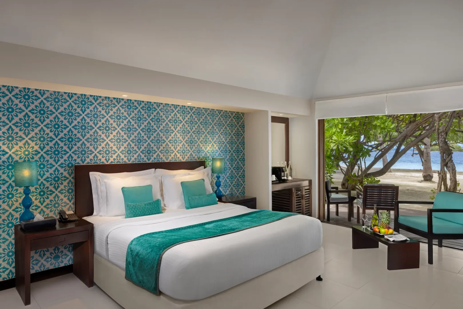 beach villa interior view with bed at adaaran select hudhuranfushi maldives