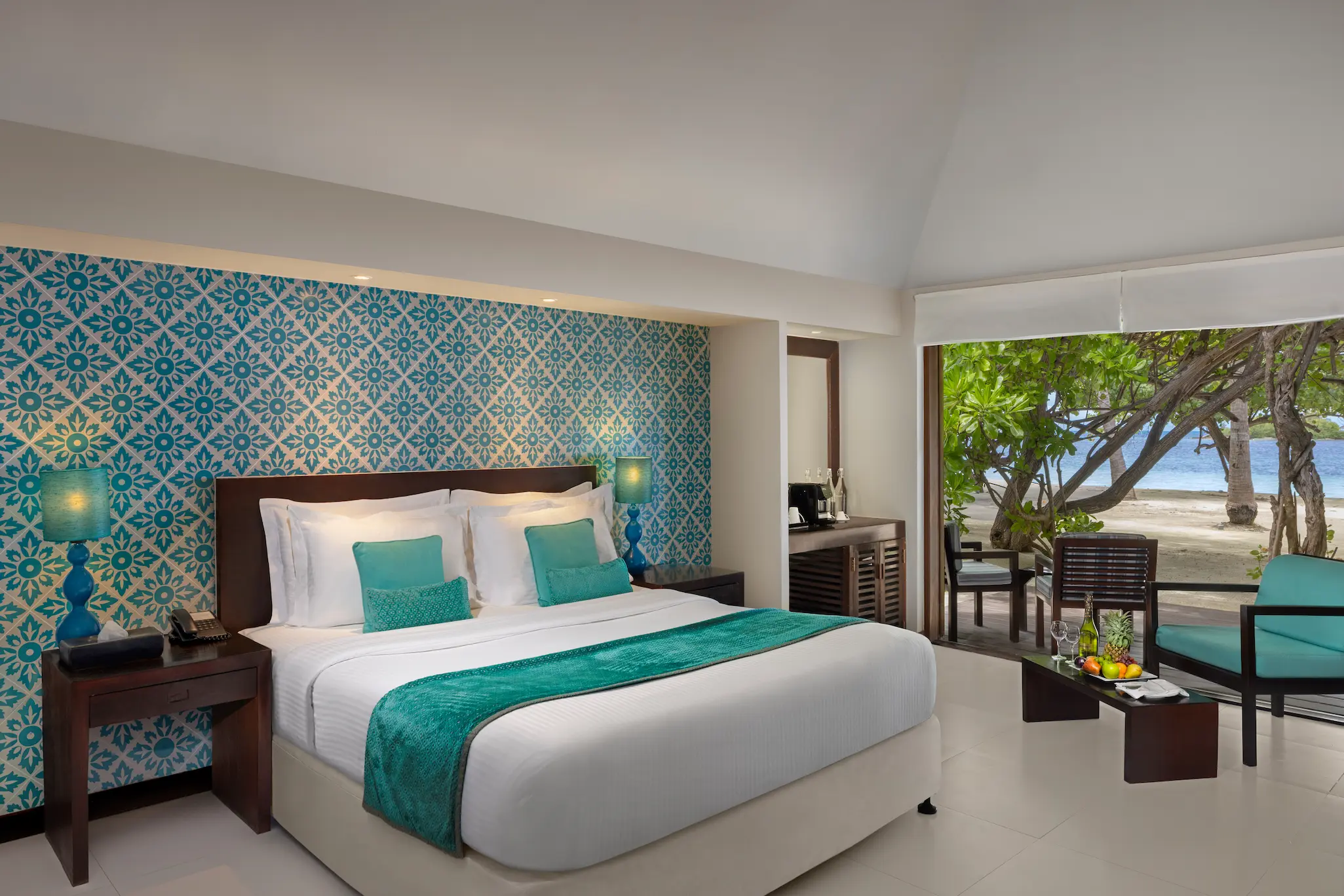 beach villa interior view with bed at adaaran select hudhuranfushi maldives