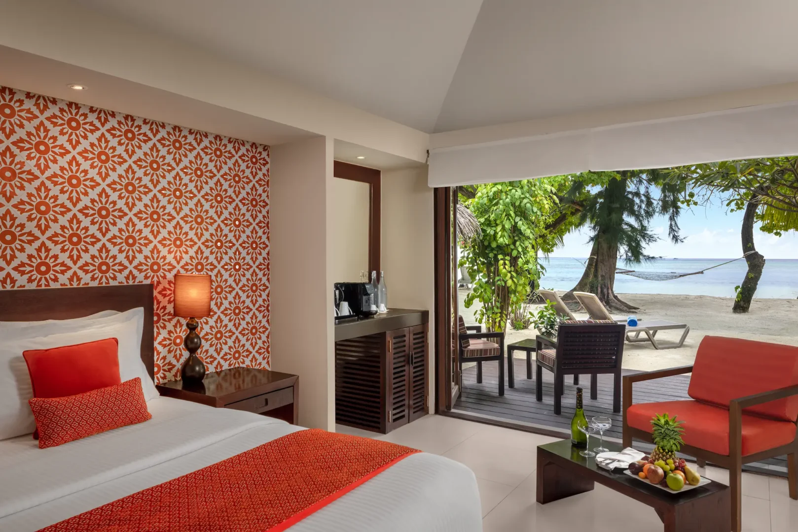 deluxe beach villa interior lounge area at adaaran select hudhuranfushi maldives