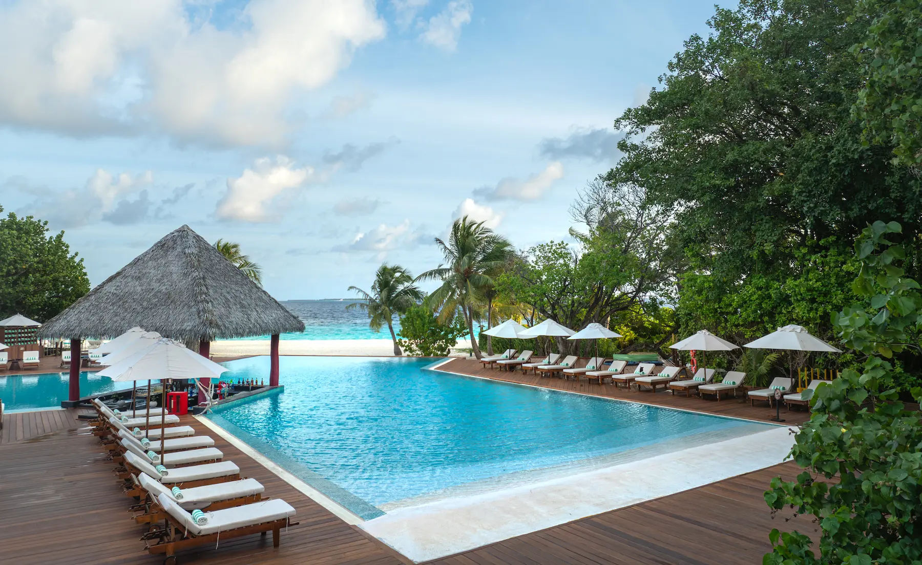adaaran select meedhupparu raa atoll maldives main pool sunbed relaxation