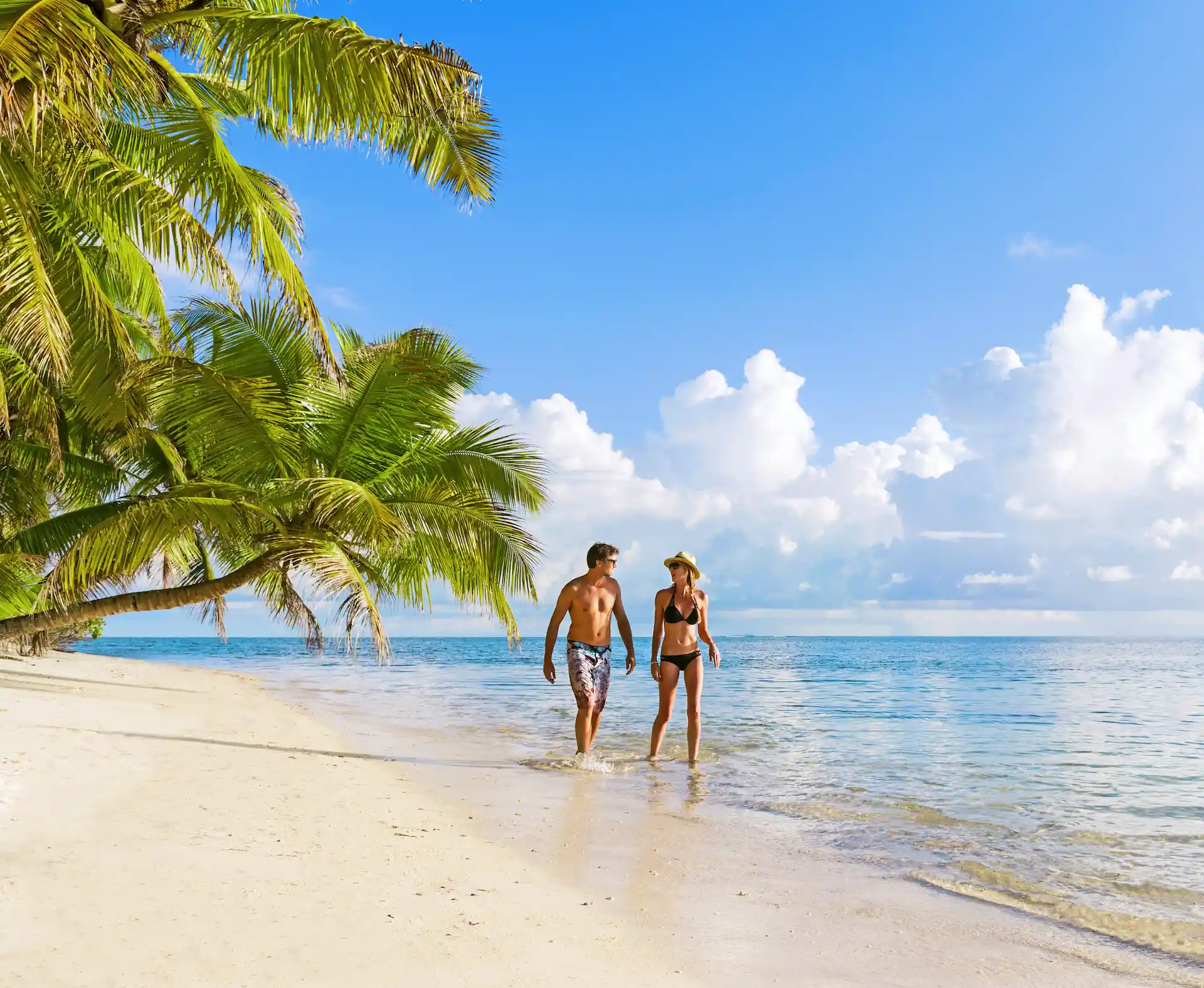 alphonse island seychelles couple on white sand beach with turquoise waters and tropical island surroundings