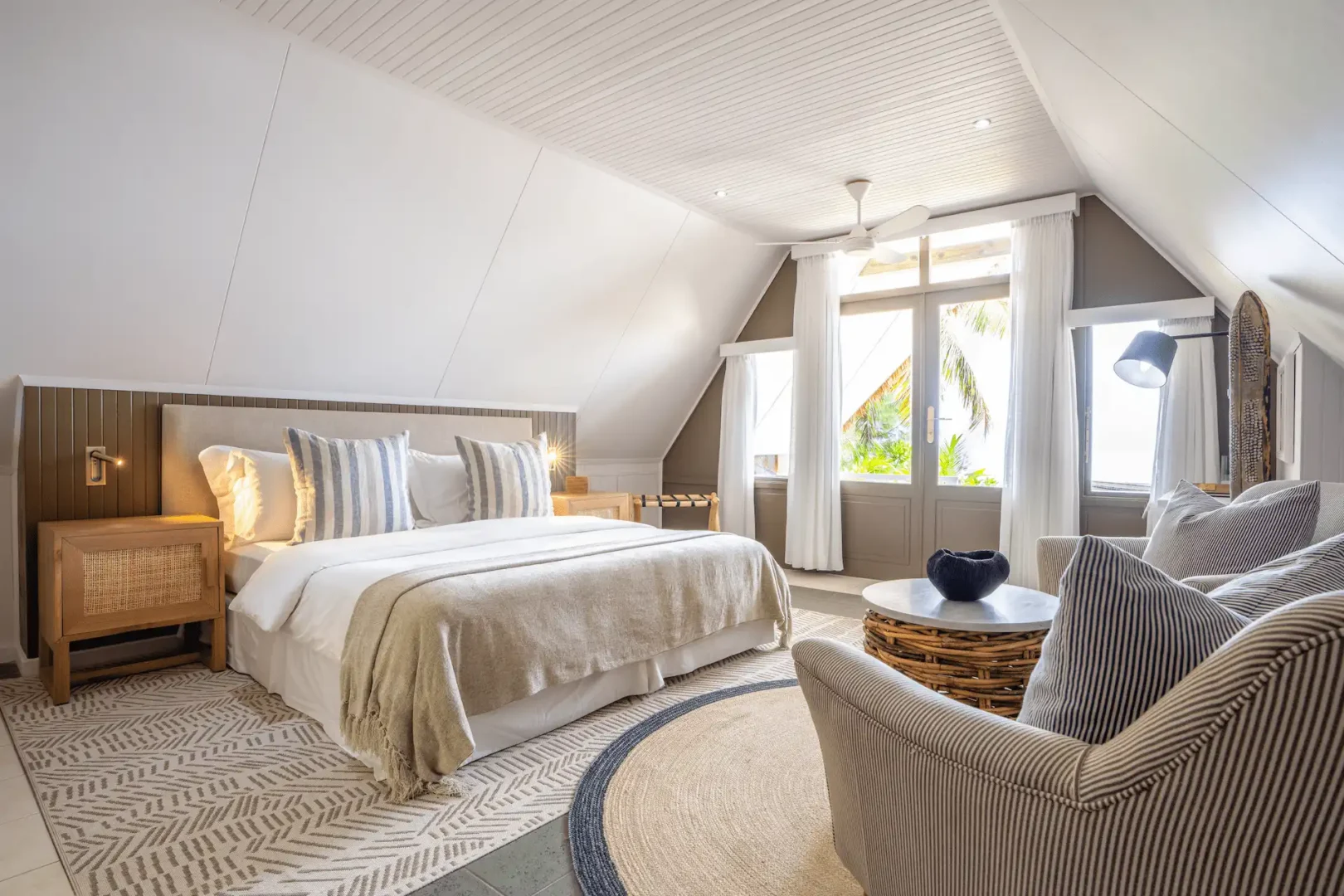 alphonse island seychelles the beach bungalow bedroom with king size bed, tropical décor, and ocean view from private terrace