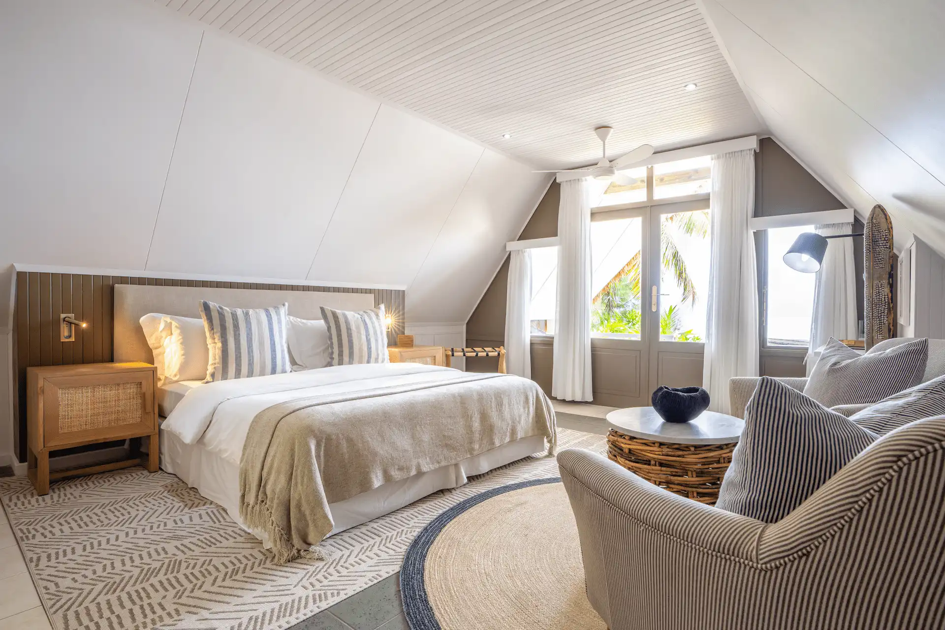 alphonse island seychelles the beach bungalow bedroom with king size bed, tropical décor, and ocean view from private terrace