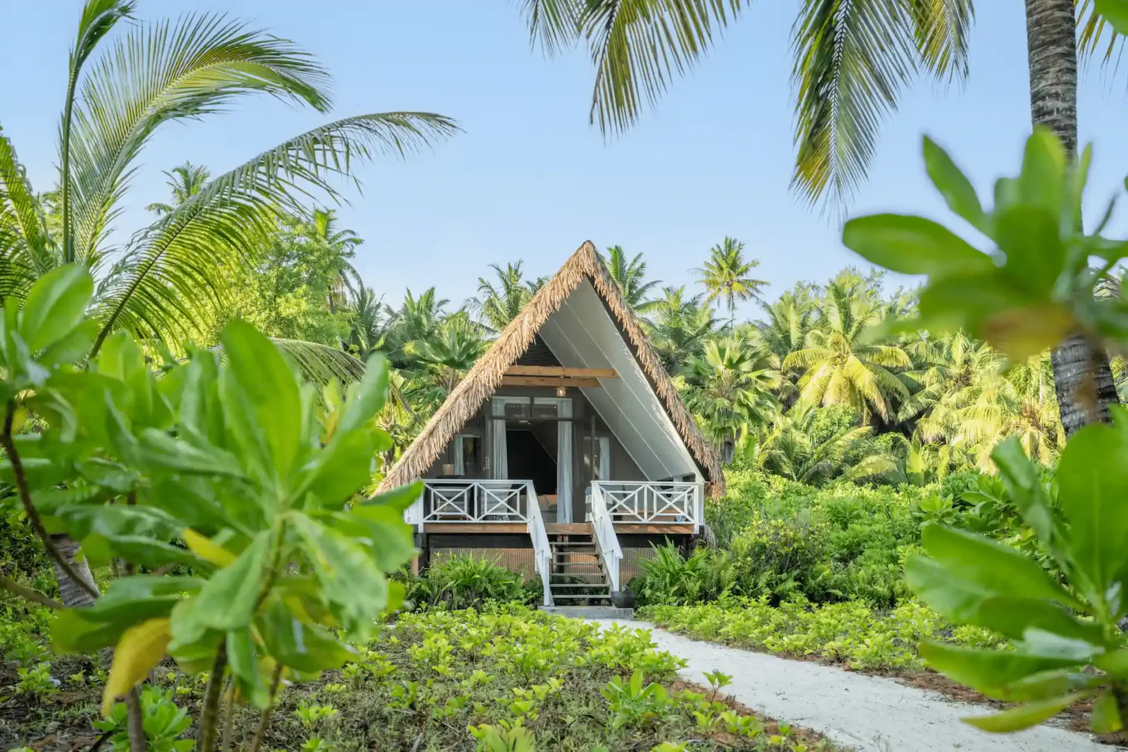 alphonse island seychelles the beach bungalow front view with private terrace, direct ocean access, and tropical garden surroundings
