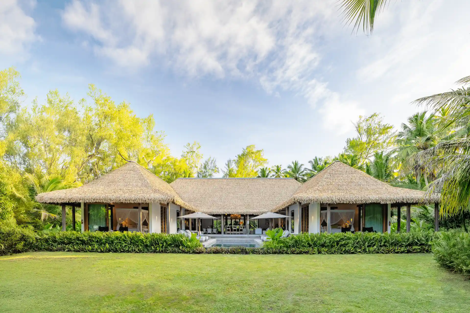 alphonse island seychelles the beach retreat exterior with private terraces, lush tropical gardens, and oceanfront views
