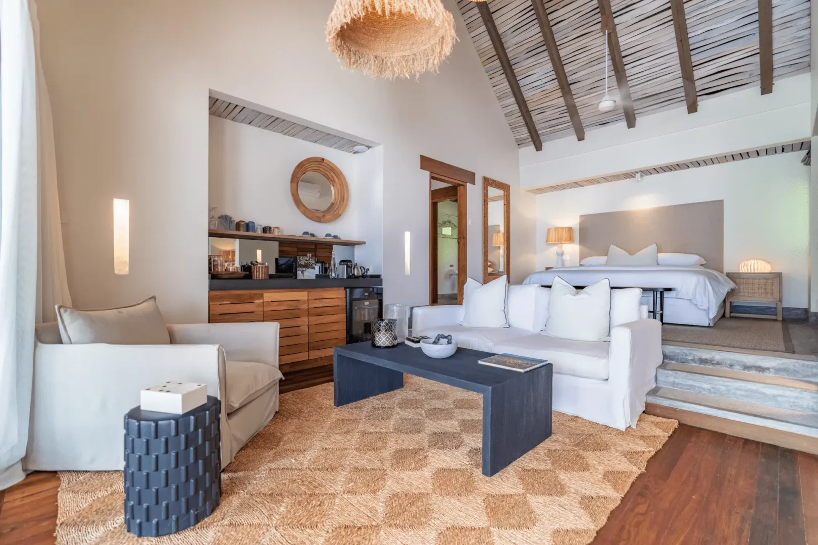 alphonse island seychelles the beach villa living area with open layout, modern furnishings, and ocean views from large windows