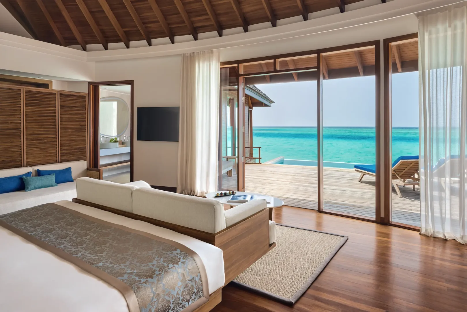 anantara dhigu maldives resort deluxe sunset over water pool villa bedroom with deck