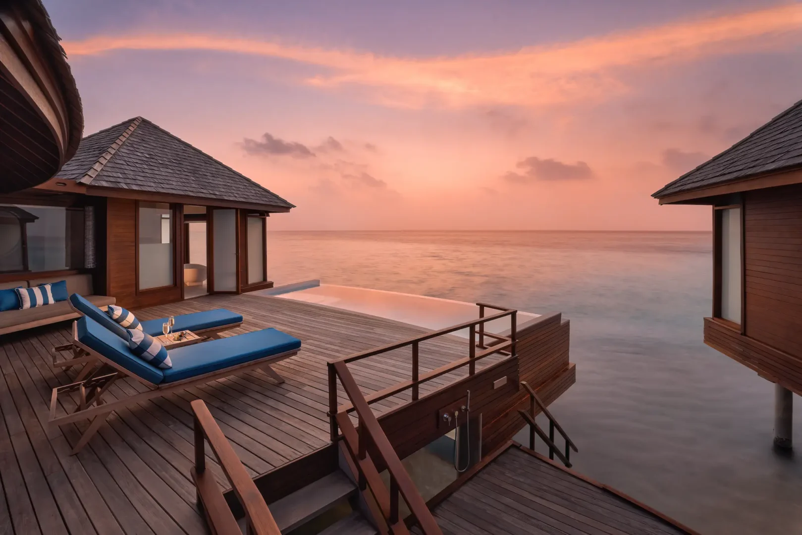 anantara dhigu maldives resort deluxe sunset over water pool villa deck sunset