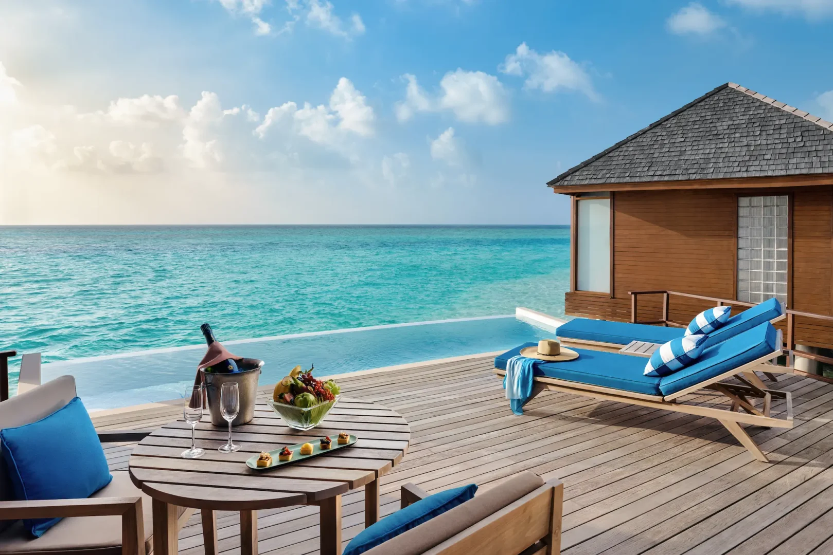 anantara dhigu maldives resort deluxe sunset over water pool villa deck with loungers