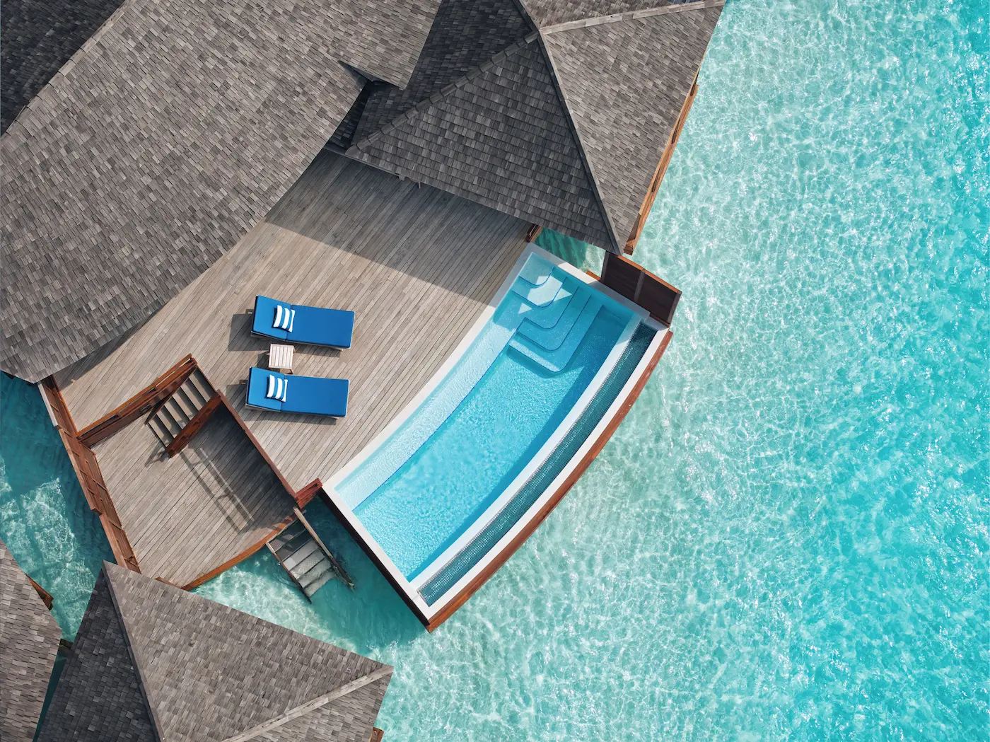 anantara dhigu maldives resort deluxe sunset over water pool villa outdoor deck aerial