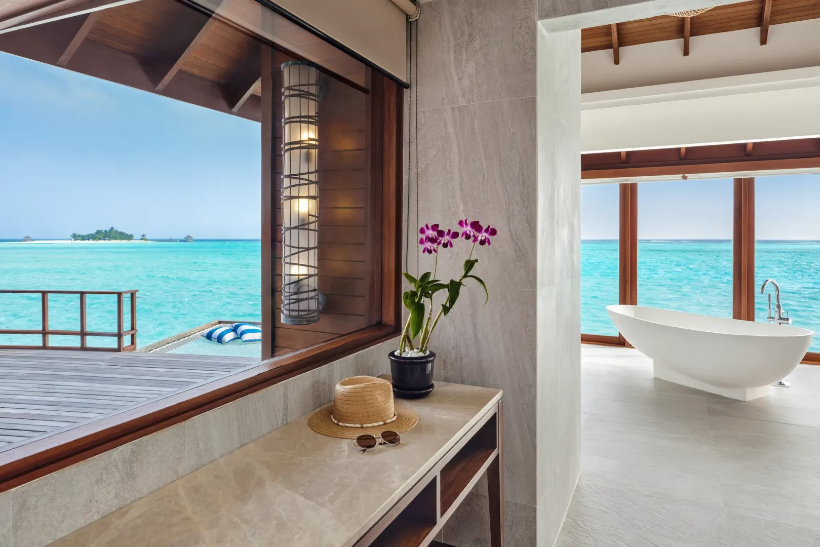 anantara dhigu maldives resort sunrise over water villa bathroom angle