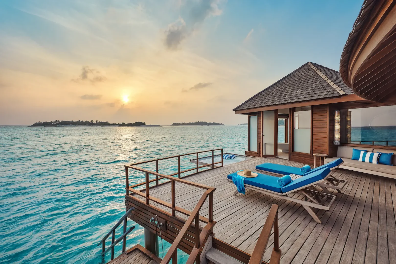 anantara dhigu maldives resort sunrise over water villa bedroom angle