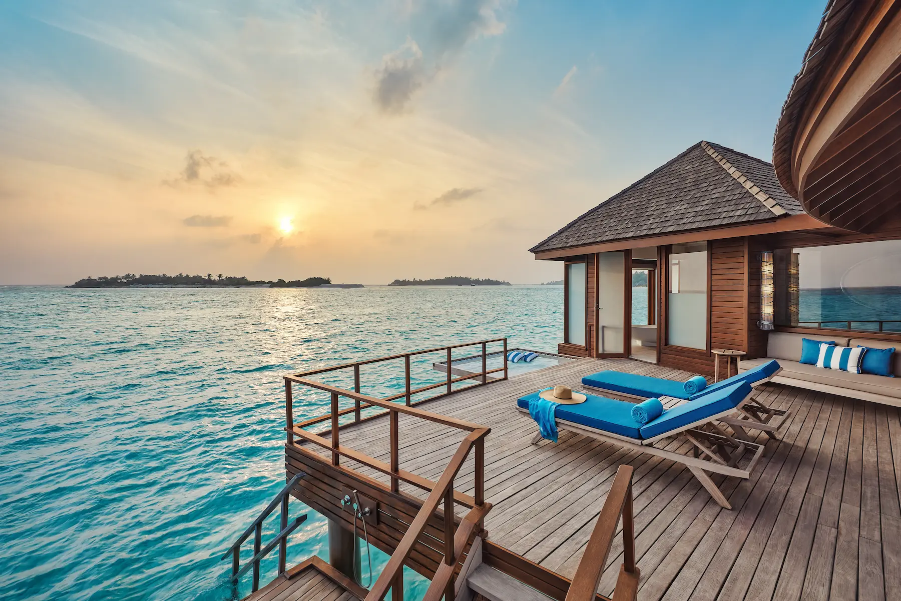 anantara dhigu maldives resort sunrise over water villa bedroom angle