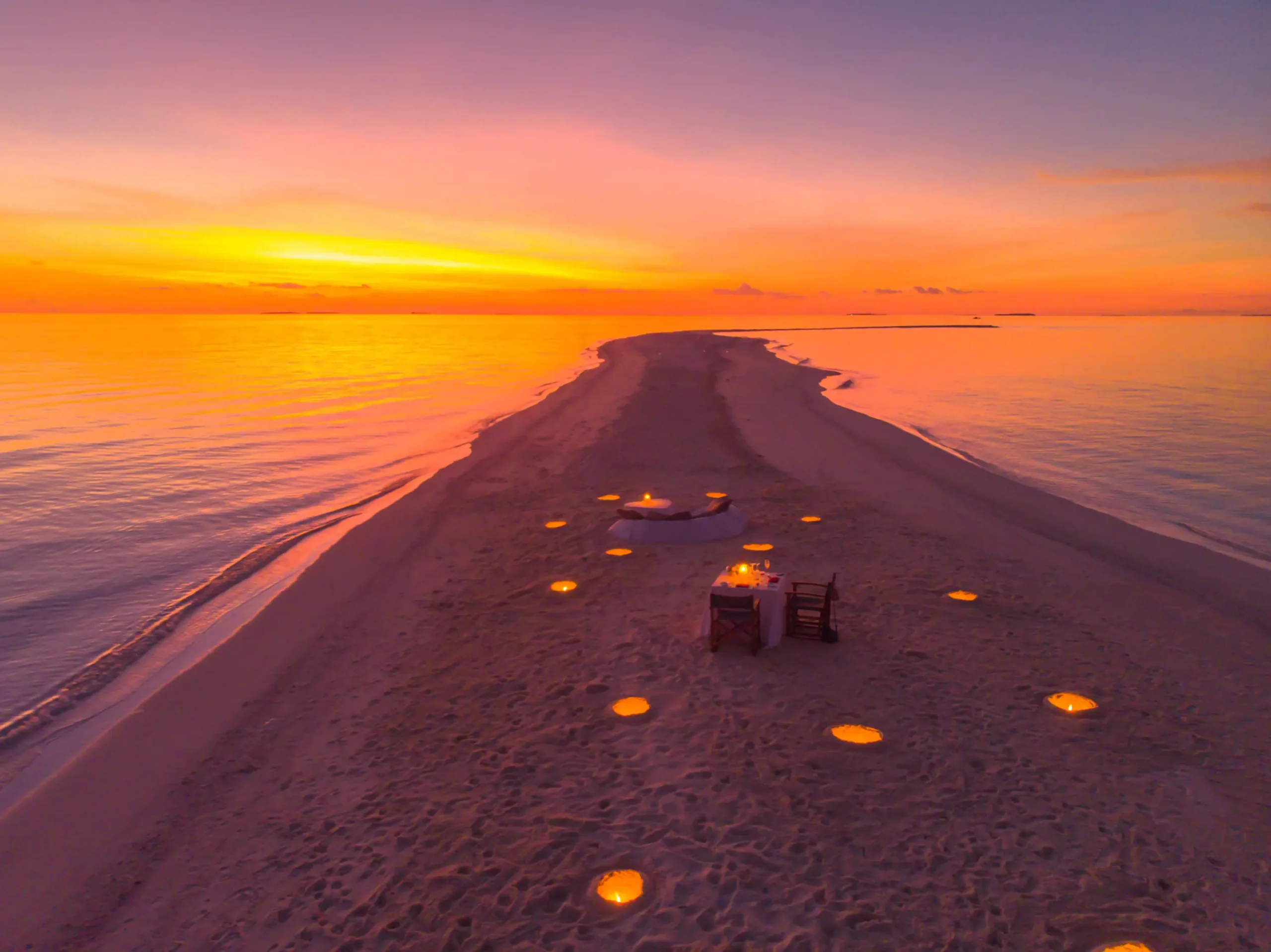 romantic dining by design beach dinner at sunset at anantara kihavah maldives villas set along a tranquil shoreline