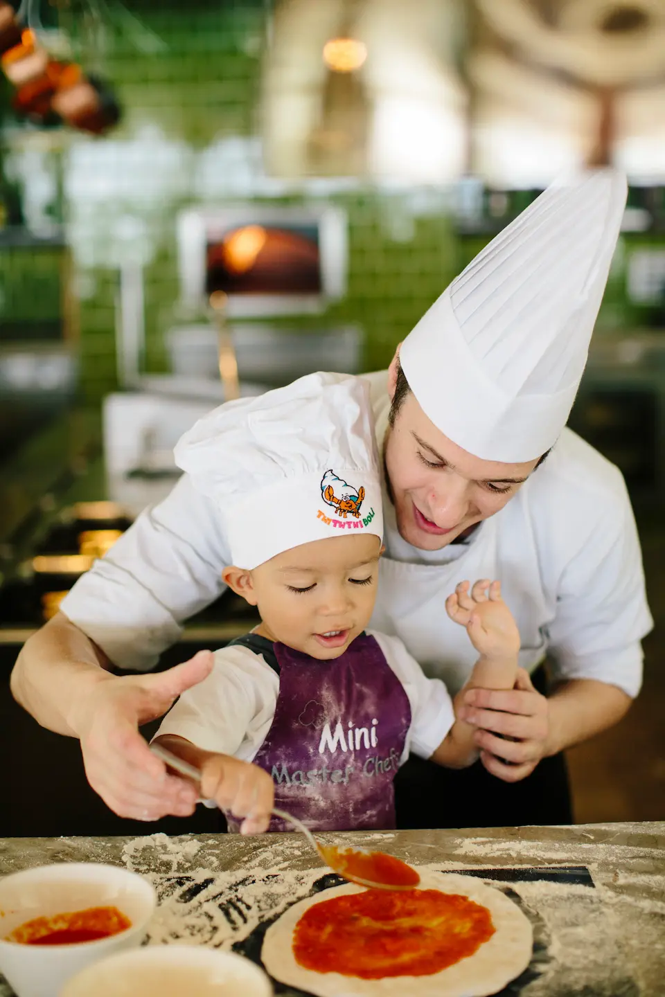 kids enjoying a fun pizza making class at anantara kihavah maldives villas in a bright and welcoming family activity setting
