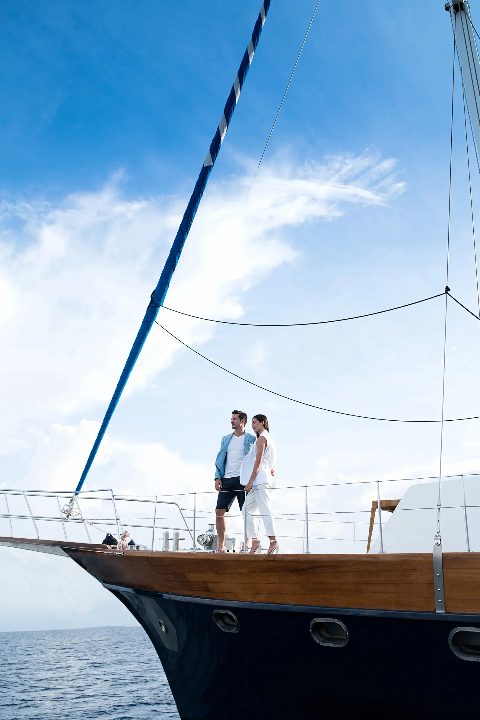 couple sailing on the ocean whisperer at anantara kihavah maldives villas gliding across calm turquoise waters